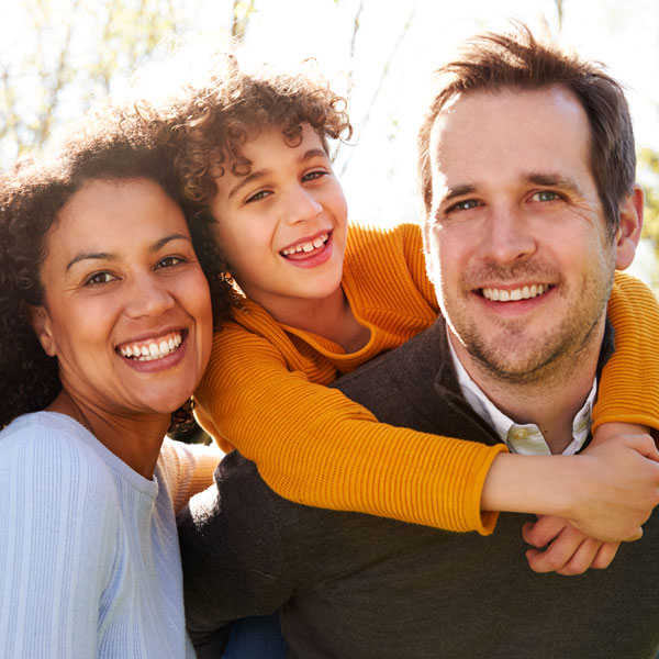 Family smiling together after a visit to Elite Smiles of Mokena